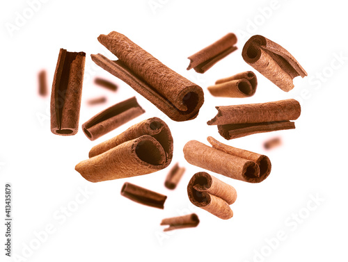 Photos Cinnamon sticks in the shape of a heart on a white background