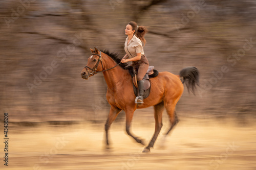 Slow pan of brunette riding in woods
