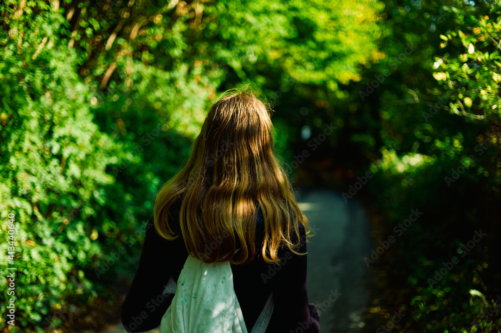 Young woman walking in the woods on an autumn day Young woman walking in the woods on an autumn day