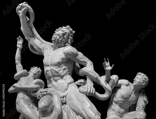 Front view of famous laocoon roman copy sculpture isolated on black background. Trojan Laocoon was strangled by sea snakes with his two sons photo