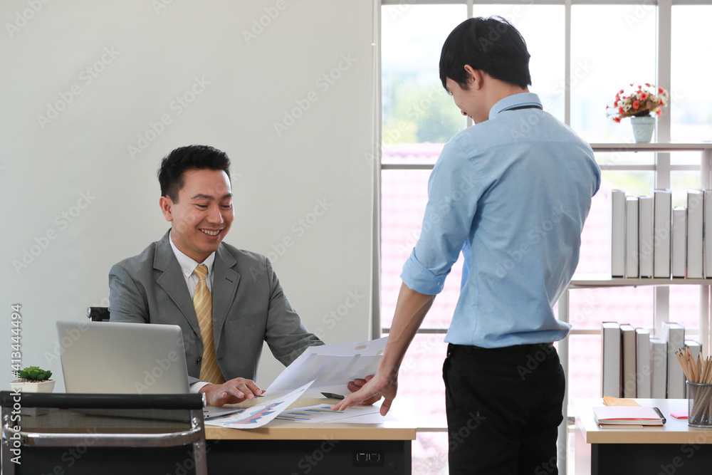 Senior Asain businessman boss satisfied and happy with young employee paperwork Senior Asain businessman boss satisfied and happy with young employee paperwork