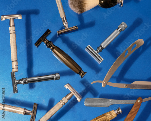 Canvas Print Different kind of razors including safety and straight, blade, brush and perfume on a blue background