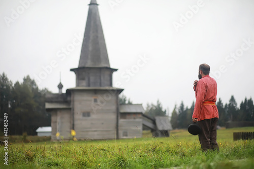 Traditional Slavic rituals in the rustic style. Outdoor in summer. Slavic village farm. Peasants in elegant robes.