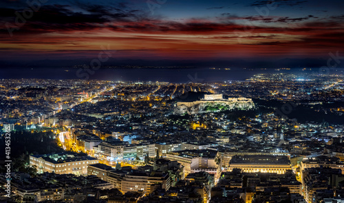 Fototapeta Naklejka Na Ścianę i Meble -  The illuminated cityscape of Athens, Greece, with the ancient Acropolis and busy streets around Syntagma square during night time