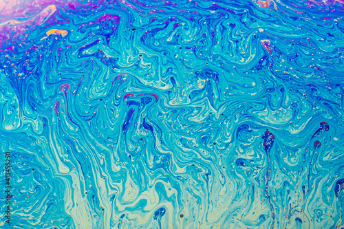 Fluid art made of colorful soap bubble film. Trendy Inkscape blurred background. Alien space planets art. Selective focus.