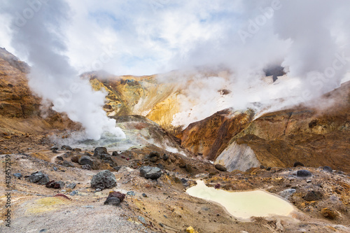 Beautiful mountain landscape, crater of active volcano: fumarole and hot spring, geothermal gas-steam activity, lava plain. Amazing volcanic landscape, travel destinations for hike, mountain climbing.