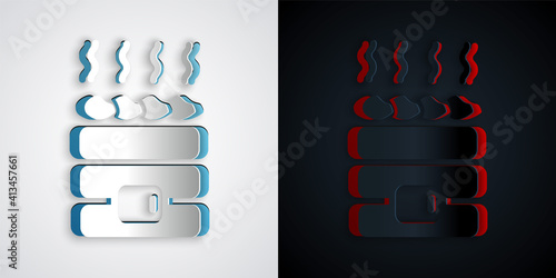 Paper cut Hot sauna stones icon isolated on grey and black background. Spa resort recreation, bathhouse relaxation. Hot stones on electric heater. Paper art style. Vector.