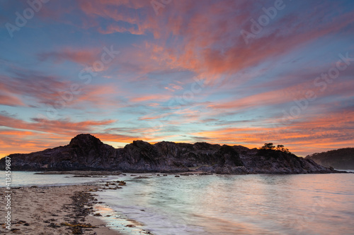 Colourful High Cloud Sunrise Seascape and Rock Formations