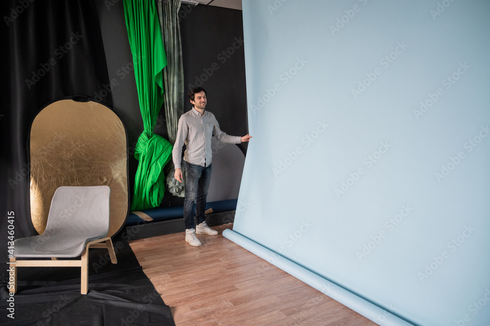 Photographer prepares for shooting in a photo studio Photographer prepares for shooting in a photo studio
