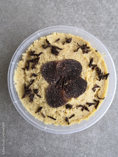 Gros plan d'un plat gastronomique garni de truffes noires et d'herbes aromatiques.