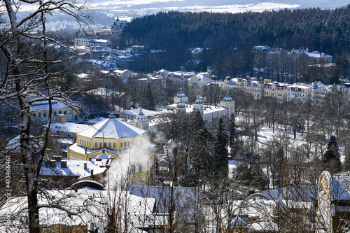 View of center of Czech town Marianske Lazne (Marienbad) from view point in spa forest - winter walk