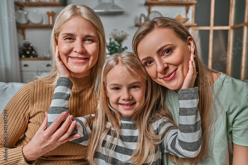 Family portrait of mother, daughter and grandmother. Generation of women. The concept of Women's Day, Mother's Day, Spring Day, psychology of child rearing, genetics, care and motherhood.