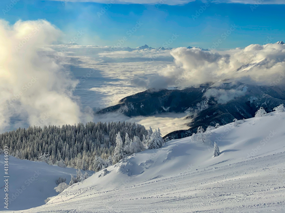 DRONE: Aerial shot of snow and mist covering distant valley and mountain range. DRONE: Aerial shot of snow and mist covering distant valley and mountain range.