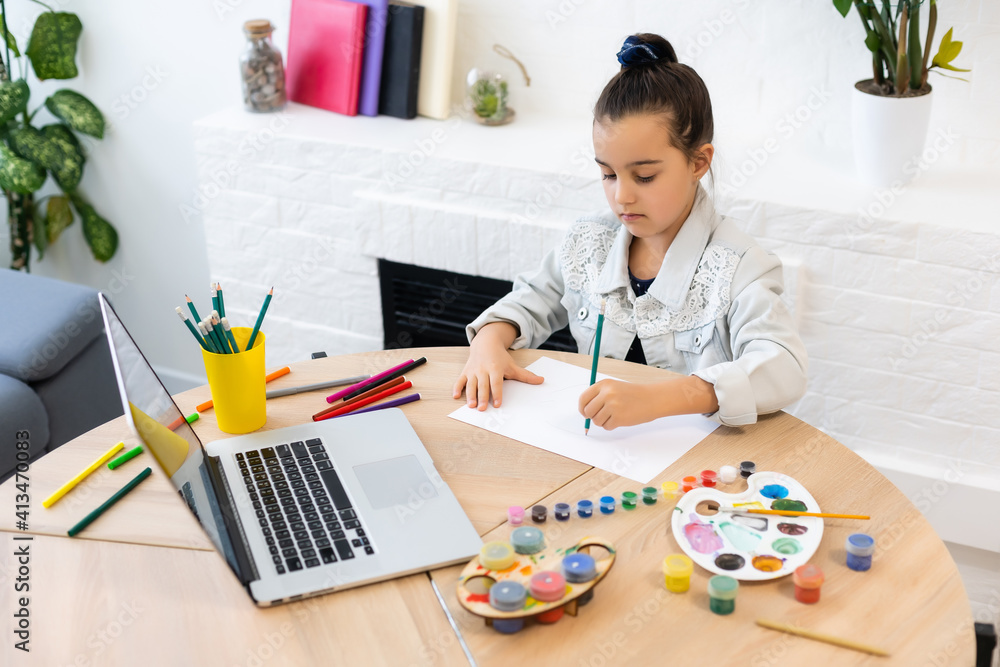 Young girl spending a time drawing using online lessons on laptop. Distance learning online education Young girl spending a time drawing using online lessons on laptop. Distance learning online education