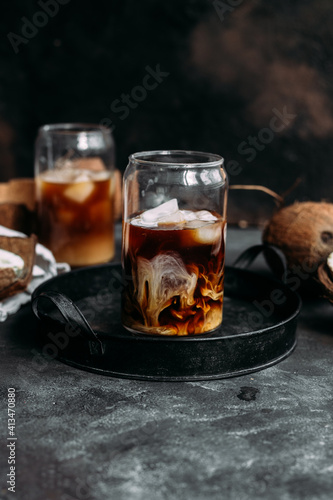 Iced coffee and coconut milk in a transparent glass