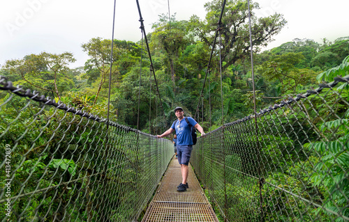 Arenal Hanging Bridges, man hiking in green tropical jungle, Costa Rica, Central America.