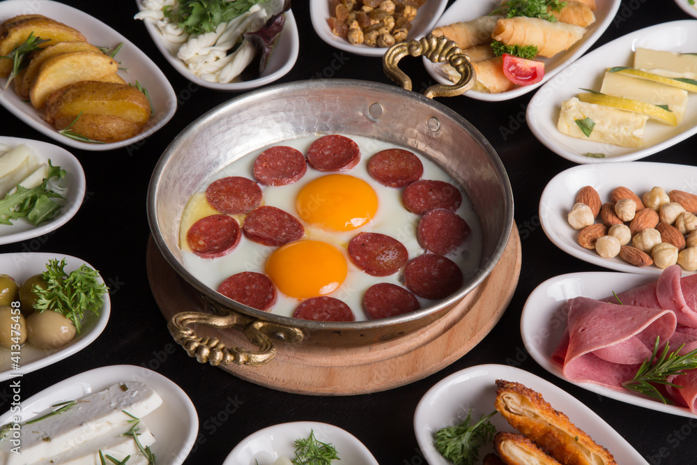 Fried eggs with sausages on a breakfast table Fried eggs with sausages on a breakfast table