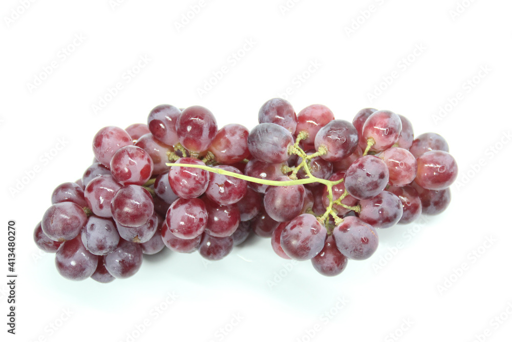 fresh purple grapes with a white background. Selective focus.