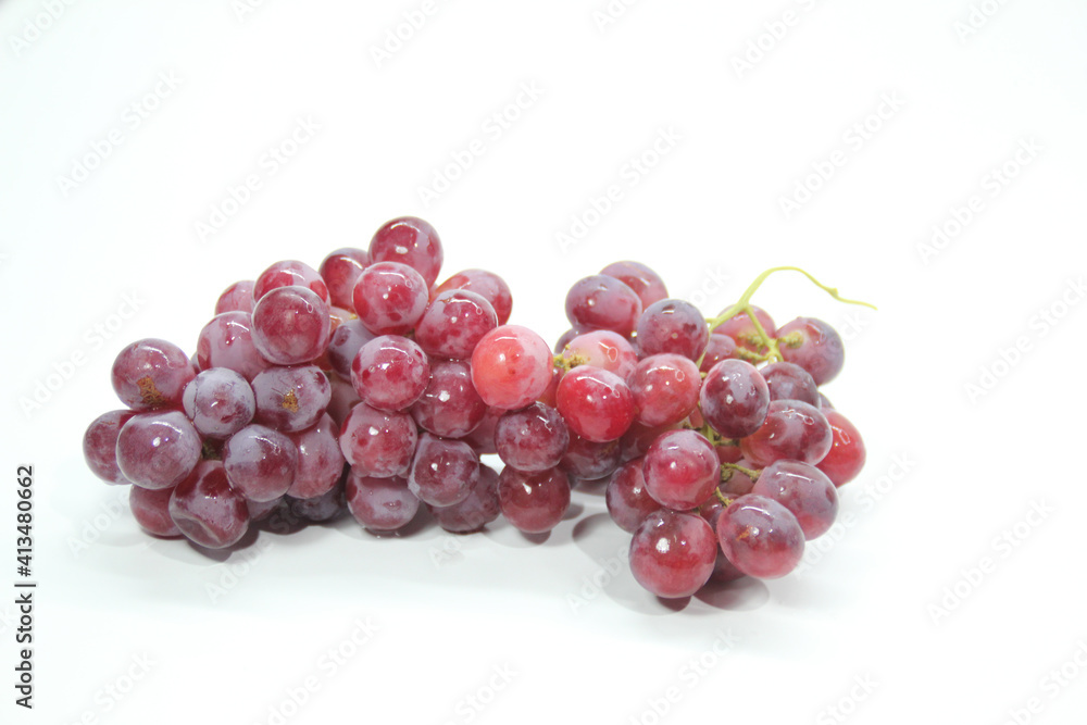 fresh purple grapes with a white background