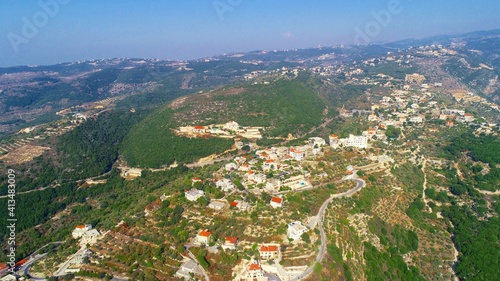 Aerial shot of the Lebanese village. High angle shot of the town. Rural scene with beautiful village view from top. Sunny day at the mountains. Hiking adventures