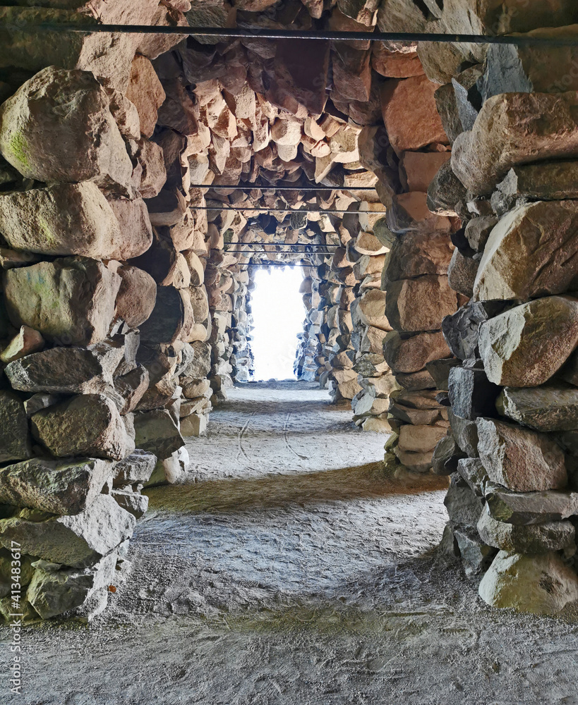Fototapeta premium wonderful large stone corridor near a castle with a light at the end