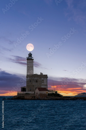 Lighthouse of the Isola Bocca with full moon, Olbia - Sardinia