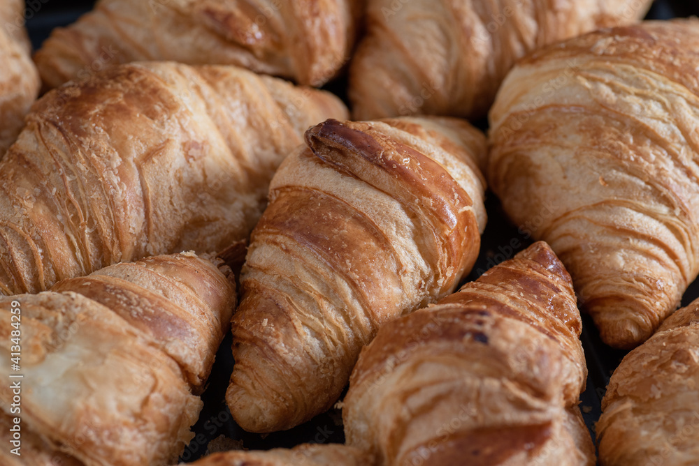Background of lots of homemade croissants. Bakery. Food texture.
