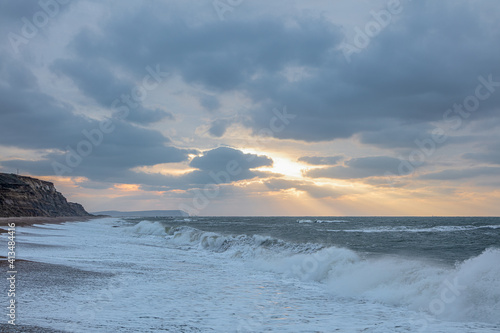 A scenic view of a choppy sea at sunrise with a stormy sky along the Jurassic Unesco world heritage site coastkine