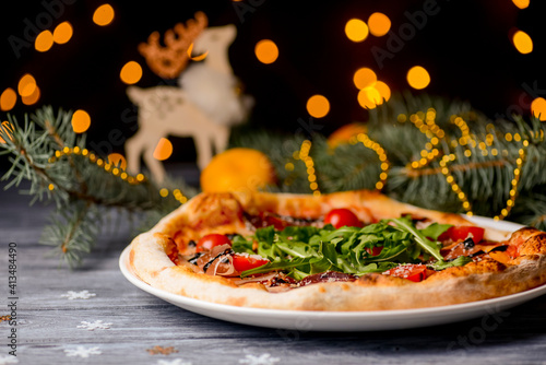Christmas pizza on the wood board. Holiday celebration pizza. Copy space banner.