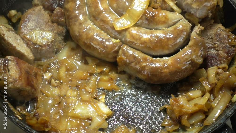 Sausage circles are fried in a pan in slow motion Sausage circles are fried in a pan in slow motion