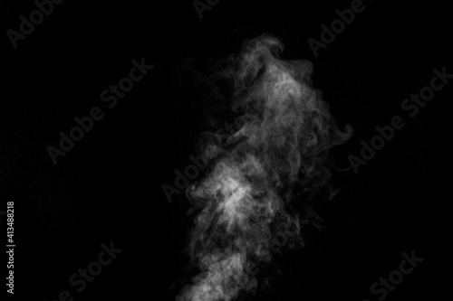 Curly white steam rising up isolated on a black background. Fog backdrop for your photos. © Alena