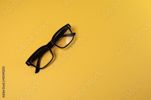 View from the top of eyeglasses isolated on the yellow background 