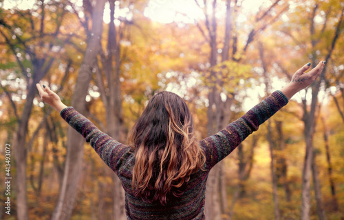 Young woman connecting with nature with open arms showing gratitude for life, Mindfulness Concept