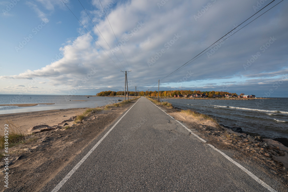 Fototapeta premium Road to an island with high altitude clouds.