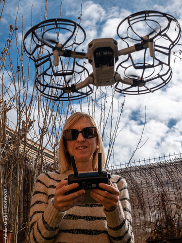 WOMAN WITH DRONE WORKING IN BUILDING