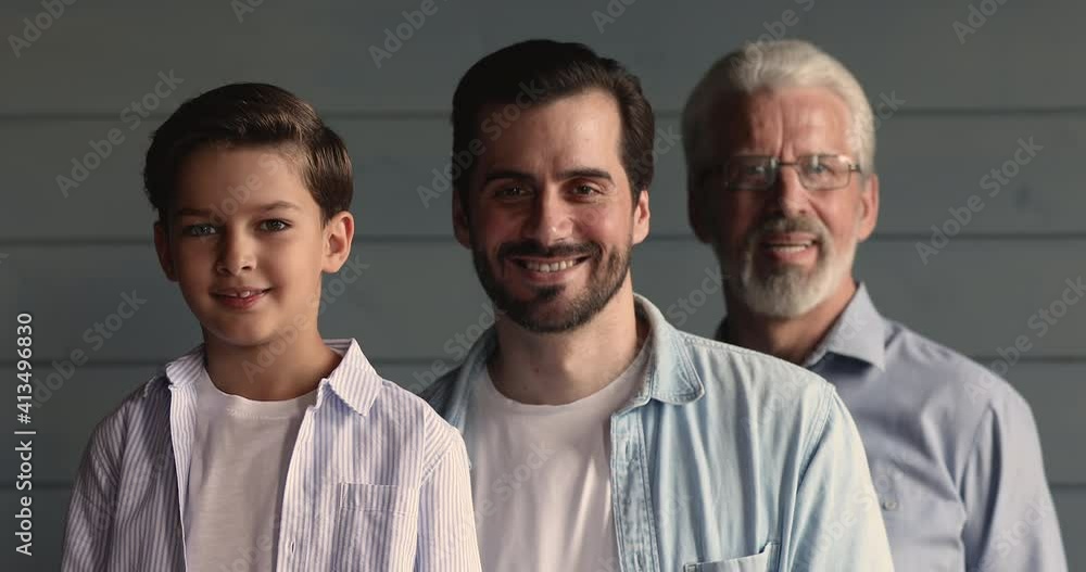 Head shot portrait of happy different male generations family. Smiling positive little boy, handsome young father and cheerful older mature grandfather standing behind each other, looking at camera. Head shot portrait of happy different male generations family. Smiling positive little boy, handsome young father and cheerful older mature grandfather standing behind each other, looking at camera.
