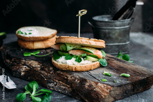 Sandwich with salmon, spinach, cream cheese, cucumber on a round toast