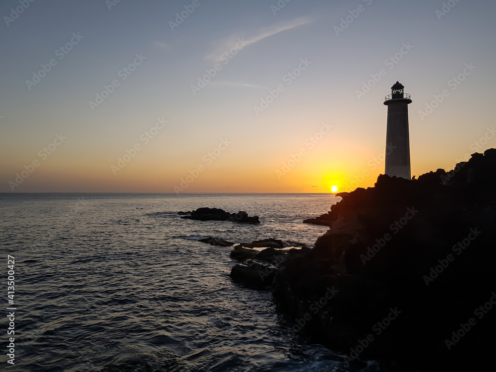 lighthouse at sunset in the sea