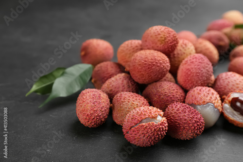 Fresh ripe lychee fruits on black table