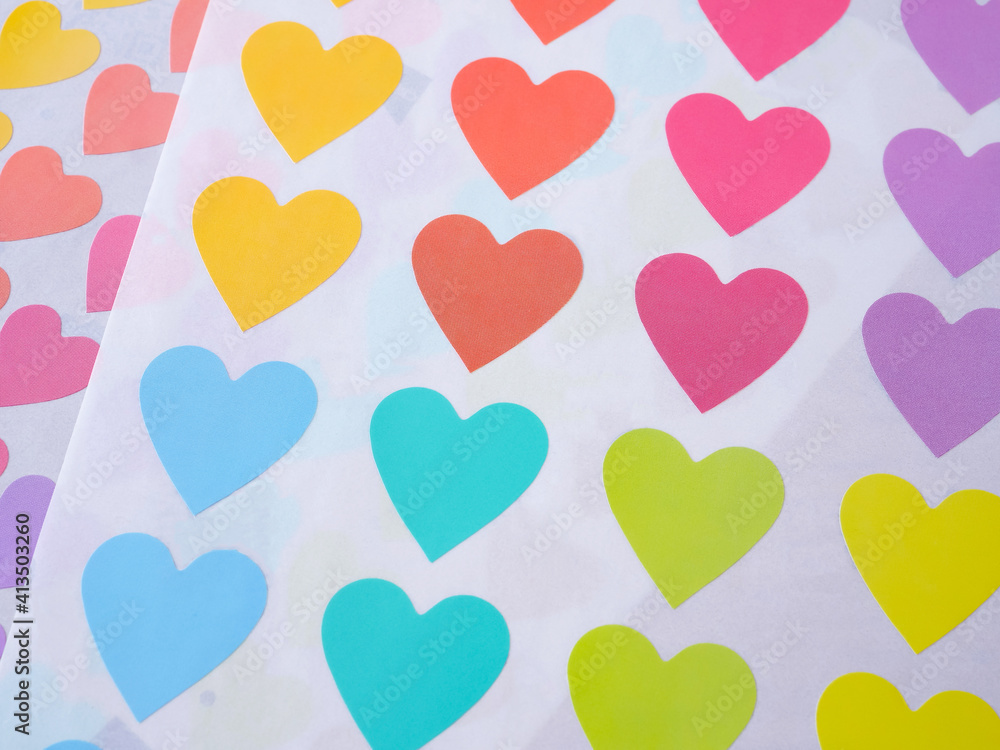 Multi-Colored heart shapes on white paper background. The concept for love, greeting card, poster..