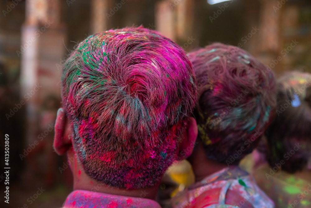 Closeup of people hair covered with color powder, holi festival celebration concept, background.