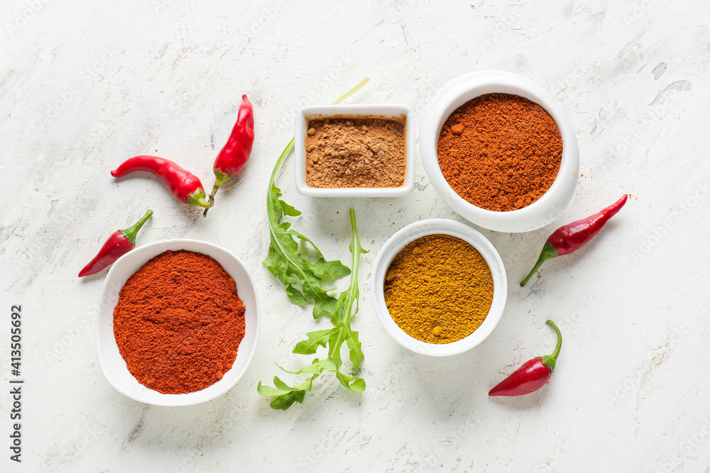 Bowls with different spices on light background - obrazy, fototapety, plakaty 