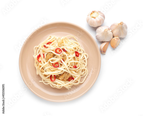 Plate with tasty noodles, chicken and garlic on white background