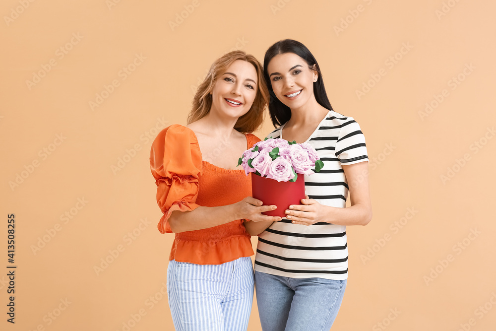 Beautiful women with flowers on color background. International Women's Day celebration Beautiful women with flowers on color background. International Women's Day celebration