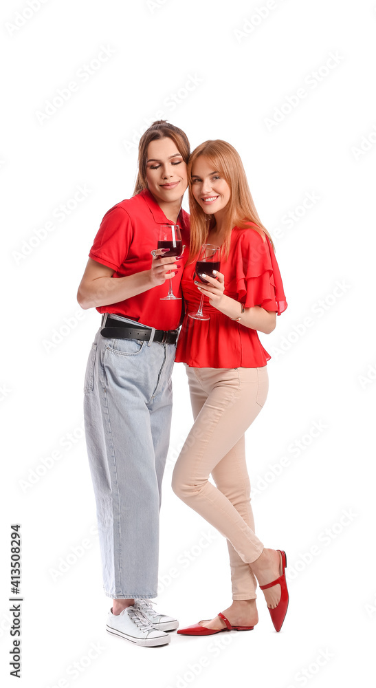 Young transgender couple with glasses of wine on white background. Valentine's Day celebration Young transgender couple with glasses of wine on white background. Valentine's Day celebration
