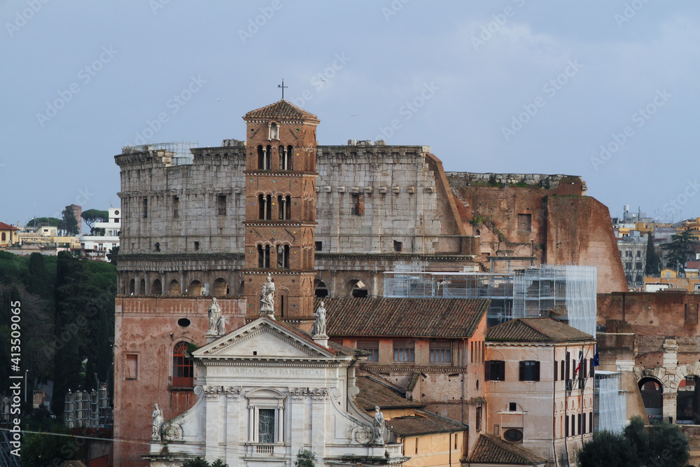 View of Rome, Basilica of Santa Maria in Cosmedin in the foreground and the Colosseum in the background.