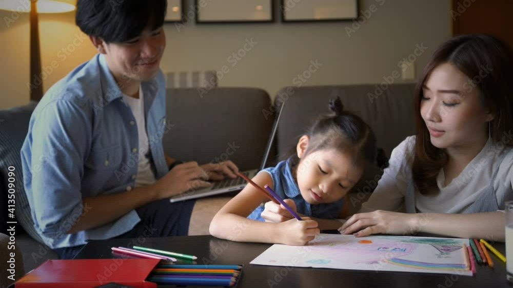 Asian parent teaching their daughter doing homework while work from home during coronavirus or covid-19 outbreak. Asian family, social distancing or homeschooling concept Asian parent teaching their daughter doing homework while work from home during coronavirus or covid-19 outbreak. Asian family, social distancing or homeschooling concept