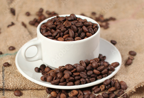 variety of roasted arabica and robusta coffee beans from Indonesia  pouring from a cup