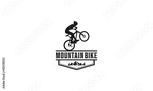 Mountain bike logo complete with illustration of a cyclist riding a bicycle with gusto