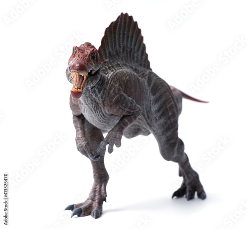 spinosaurus toy stands isolated on white background. photo